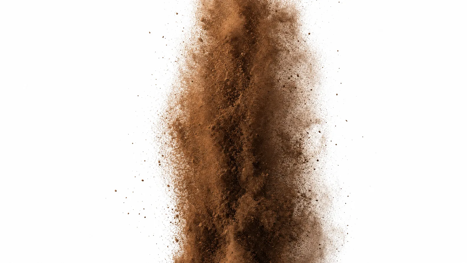 Fine ground coffee rising in a plume against a white background